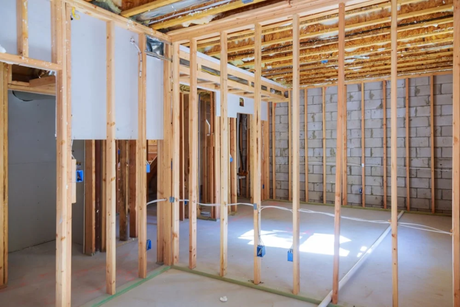 DIY basement framing with wood stud walls built in front of the foundation