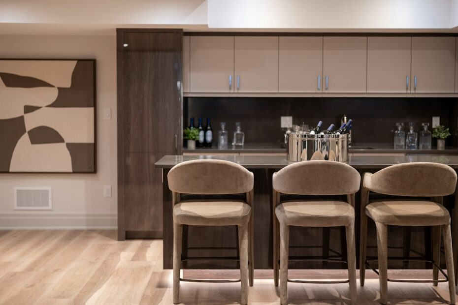 Modern home bar area with three bar stools and wine bottle storage